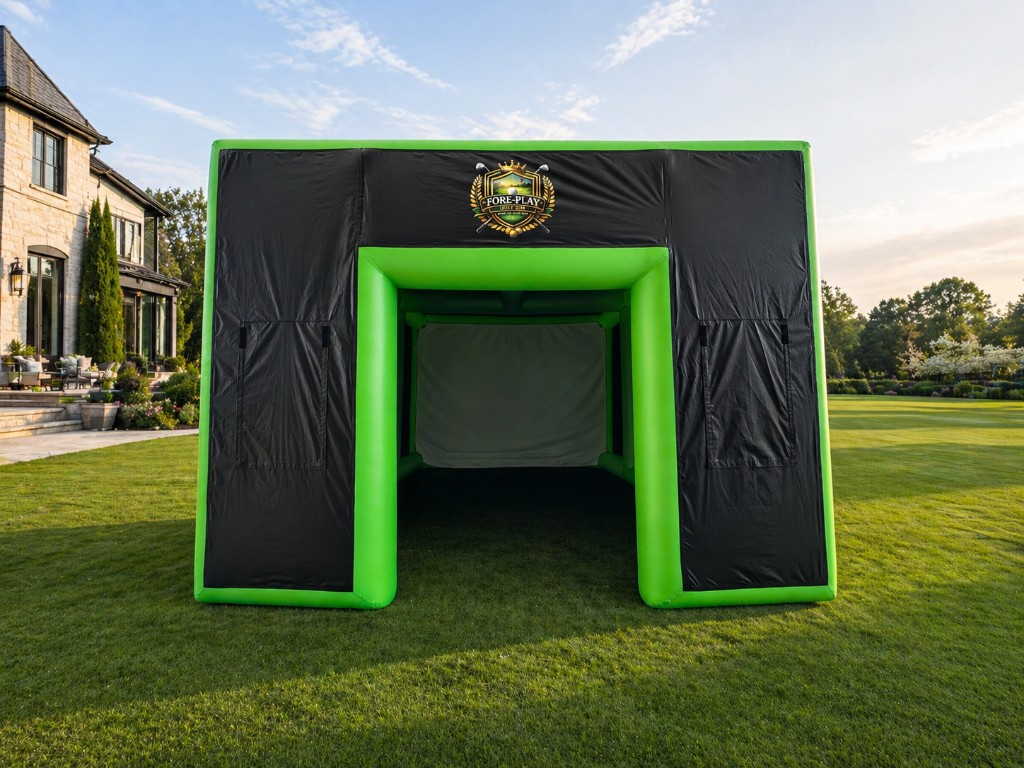 Fore-Play Golf branded inflatable golf simulator set up outdoors on green lawn with projection screen visible.