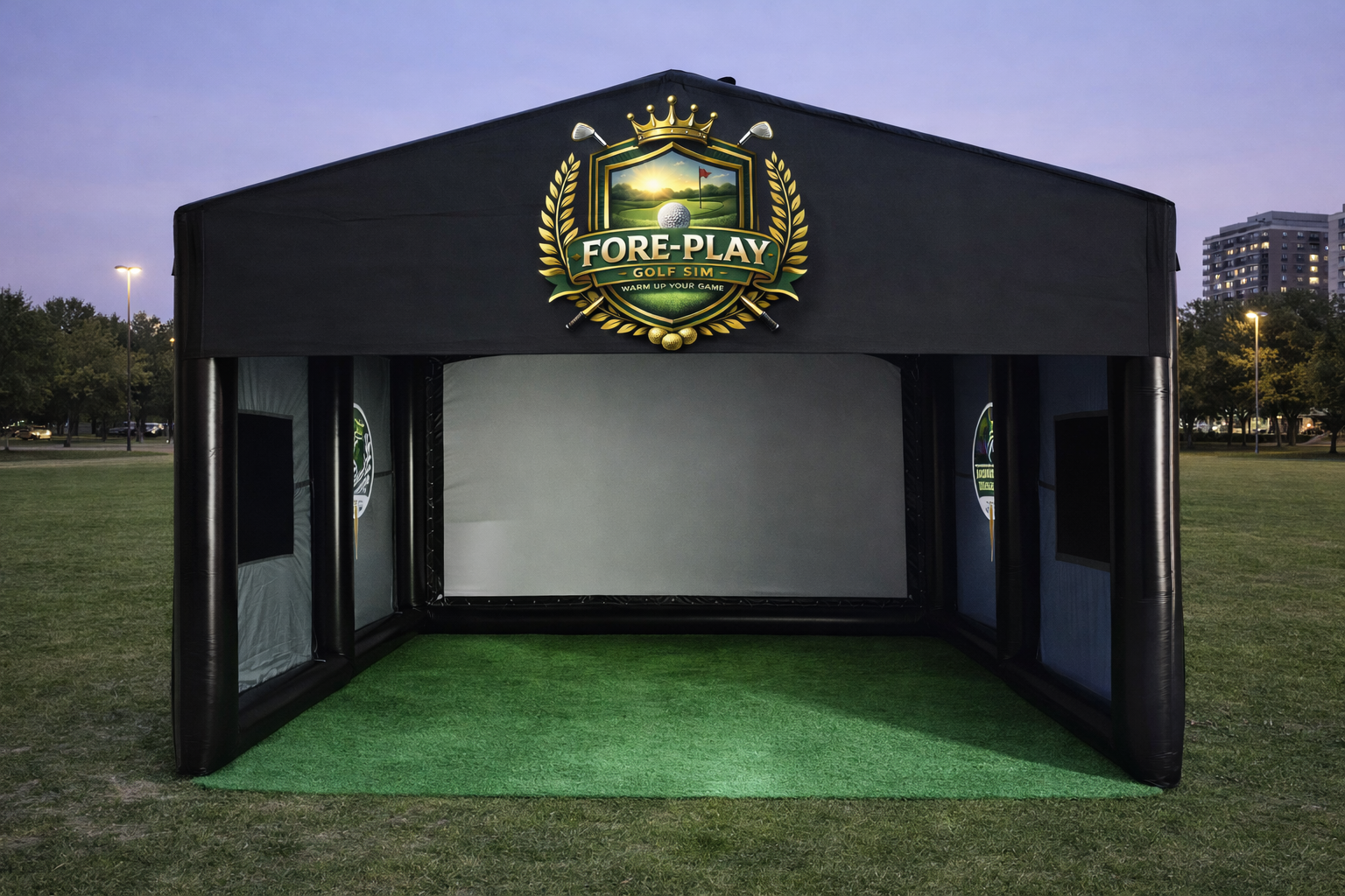 Black inflatable golf simulator at dusk with projection screen and branding visible.